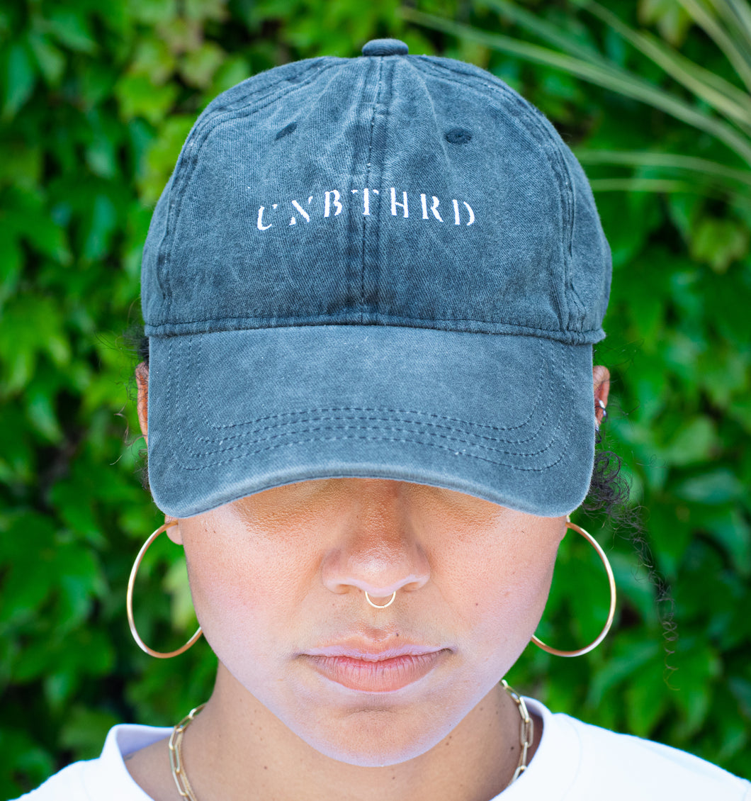 UNISEX DISTRESSED BASEBALL CAP. UNBOTHERED LOGO EMBROIDERED. VINTAGE BLACK COLOR