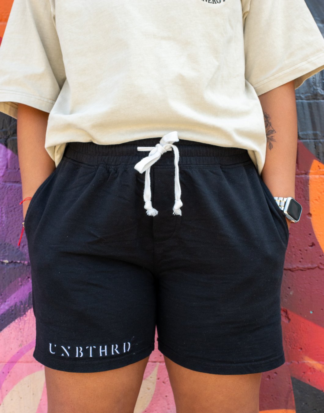 BLACK UNISEX 100% COTTON SHORTS. WHITE TIE STRINGS. EMBROIDERED LOGO ON RIGHT LEG. 